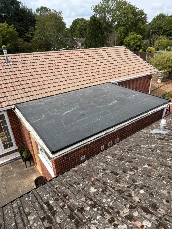 After replacement - completed black flat roof membrane with finished perimeter edge trims. By Norfolk Exterior Solutions.